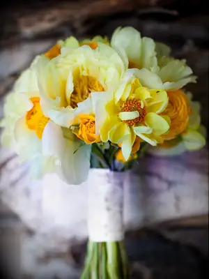 A vibrant yellow bouquet, bursting with peonies.