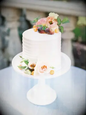 elegant one tier wedding cake with blush garden roses, sliced figs and greenery