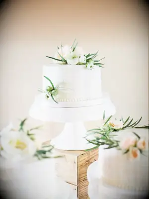 classic one tier wedding cake with white buttercream and white flowers