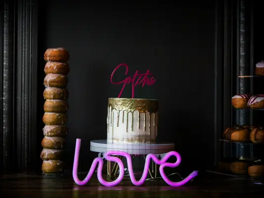 modern one tier wedding cake with neon sign decoration