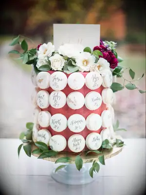 one tier wedding cake decorated with macarons and fresh flowers