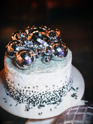 unique one tier wedding cake decorated with silver disco balls and silver metallic sprinkles