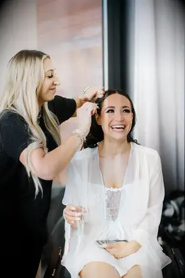 Bride wearing lingerie while getting glammed