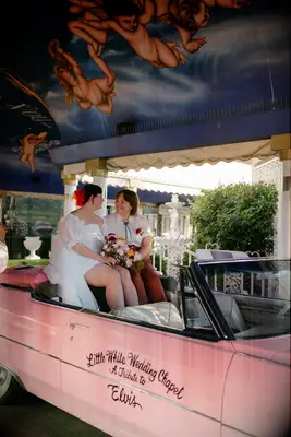 Couple in vintage pink car
