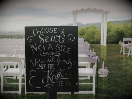 Tie the knot meaning used on black chalkboard ceremony sign. 