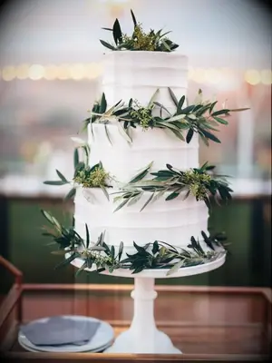 three-tier wedding cake decorated with olive branches 
