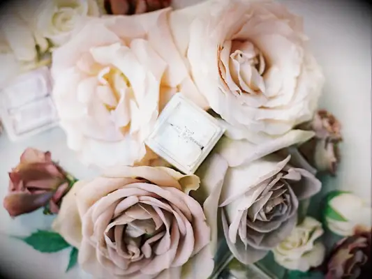 fresh roses surrounding diamond engagement ring