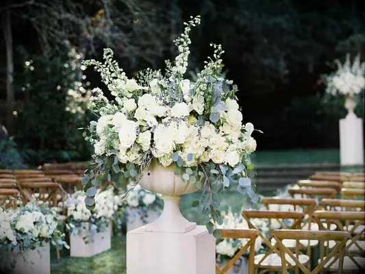 wedding ceremony aisle floral arrangement with stock and eucalyptus