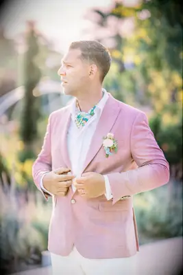groom wearing light pink sportcoat with white button down shirt