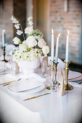 wedding tablescape with pastel blue and white ombre taper candles in gold candlesticks