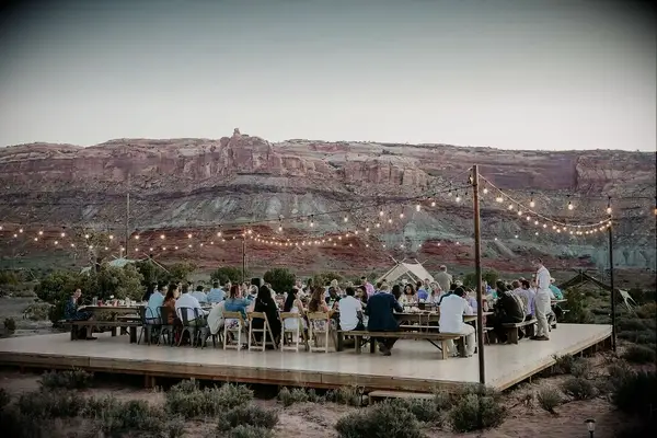 Unique Rustic Desert Reception with String Lights and Dining Tables at Under Canvas in Moab, Utah 