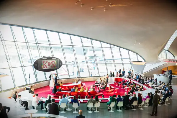 Couple getting married inside the retro TWA Hotel wedding venue in Queens, New York