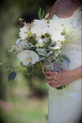 A White Bouquet Featuring Daisies, Orchids and Dusty Miller
