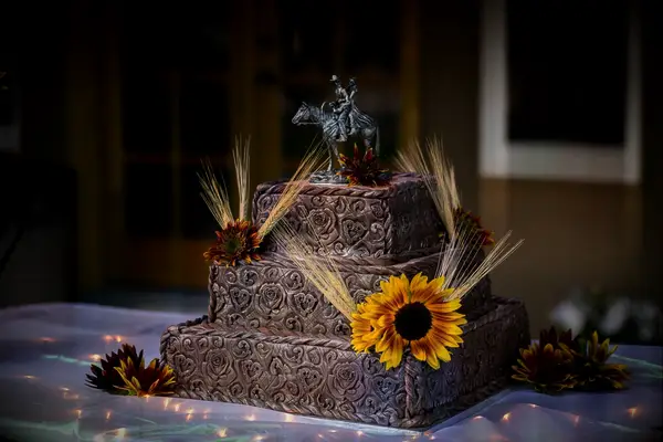 Square-shaped three-tiered wedding cake with a beautiful finish designed to look like leather detailing. 