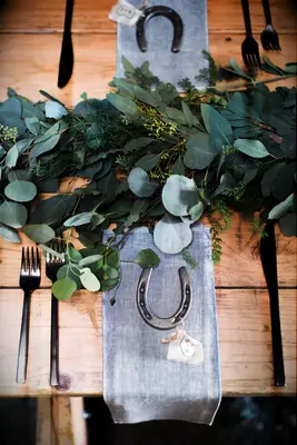 Rustic horseshoe wedding favor set on the reception dining table. 