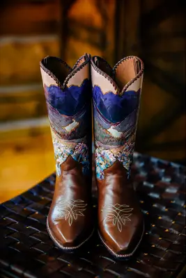 Custom hand-painted cowboy boots depicting a beautiful landscape. 