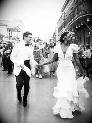 Photojournalistic image of Bride and Groom dancing in the street 