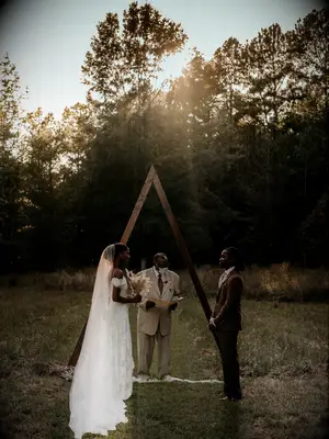 Dark and moody image of bride and groom at their outdoor ceremony