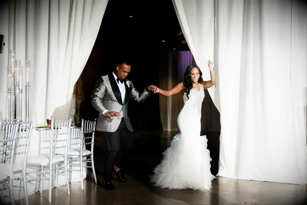 bride and groom in formal attire dance through wedding reception venue