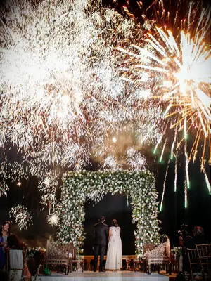 Bride and groom watching fireworks display at wedding reception