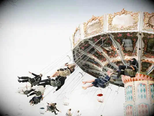 Wedding guests riding wave swinger amusement ride as a wedding reception entertainment idea.