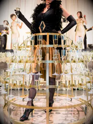 Champagne server at wedding reception with metal skirt holding champagne glasses