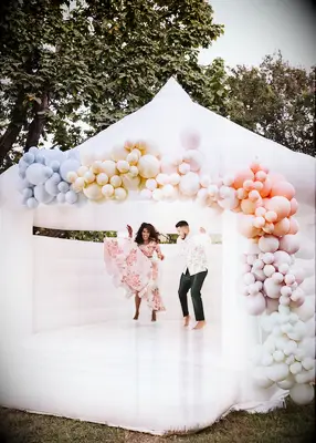 Couple on a bouncy castle at their wedding
