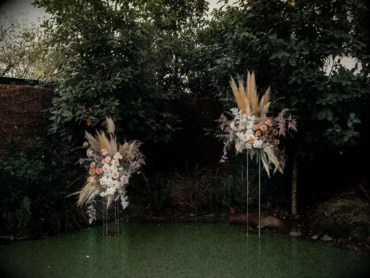 Two-piece wedding arch at a backyard wedding
