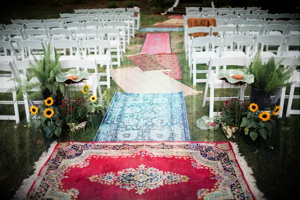 Bohemian rug aisle runners at a backyard wedding