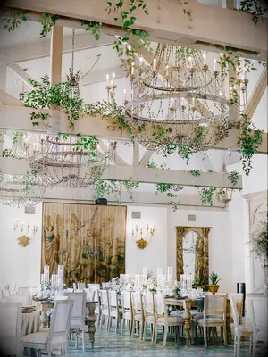Boho chandelier and greenery wedding reception space