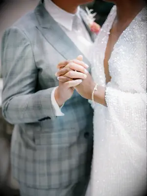 The happy couple dance together in grey and silver wedding attire