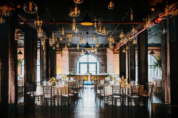 indoor wedding reception venue with edison bulbs in different sizes hanging from the ceiling