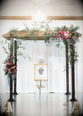 Natural wood chuppah with flowers at Jewish wedding