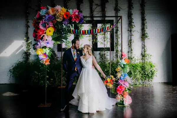 Colorful faux flowers on chuppah at Jewish wedding