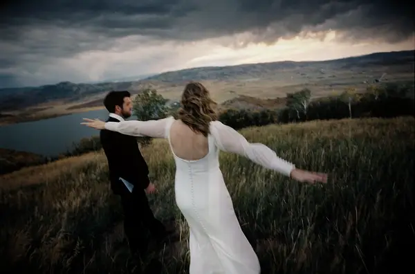 Bride and groom on mountainside blurry wedding photo