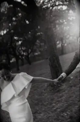 Bride and groom holding hands and smiling blurry wedding photo trend
