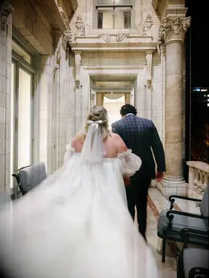 Blurry action wedding photo of bride and groom walking away