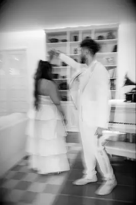 Groom spinning bride around blurry black and white wedding photo trend