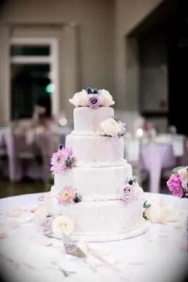 Pink and white tiered cake with piped and real flowers