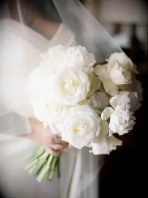 Bride holding white bouquet of flowers