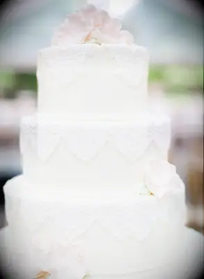Off-white tiered cake with white piping