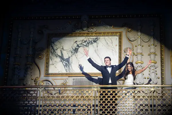 Bride and groom in a big spotlight.