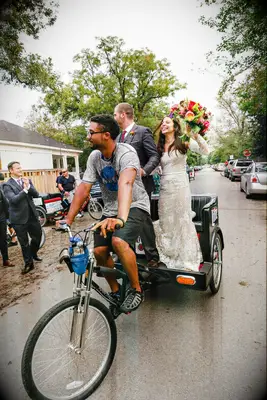 Bride and groom riding in a pedicab. 