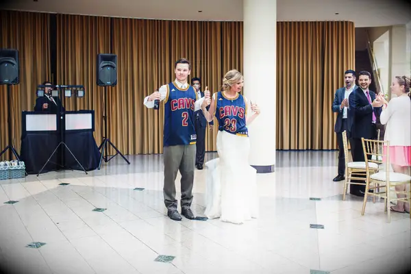 Bride and groom wearing Cleveland Cavaliers jerseys. 