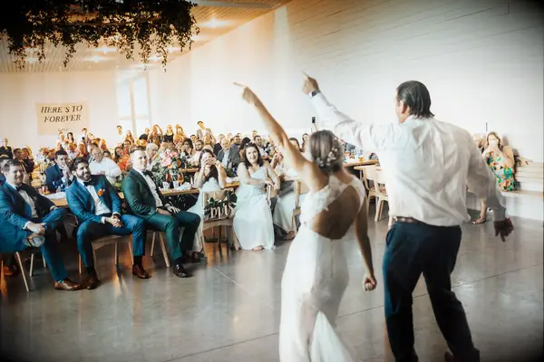 Bride and groom dancing in front of guests. 