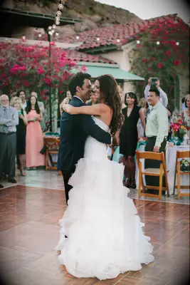 Bride and groom slow dancing on the dance floor. 