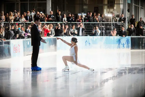 Bride and groom doing a ice skating performance.
