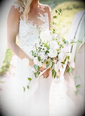 Cascading white bouquet with roses and ranunculus