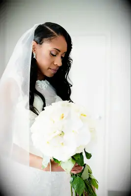 Bride holding elegant white wedding bouquet