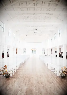 Ceremony in airy white warehouse venue
